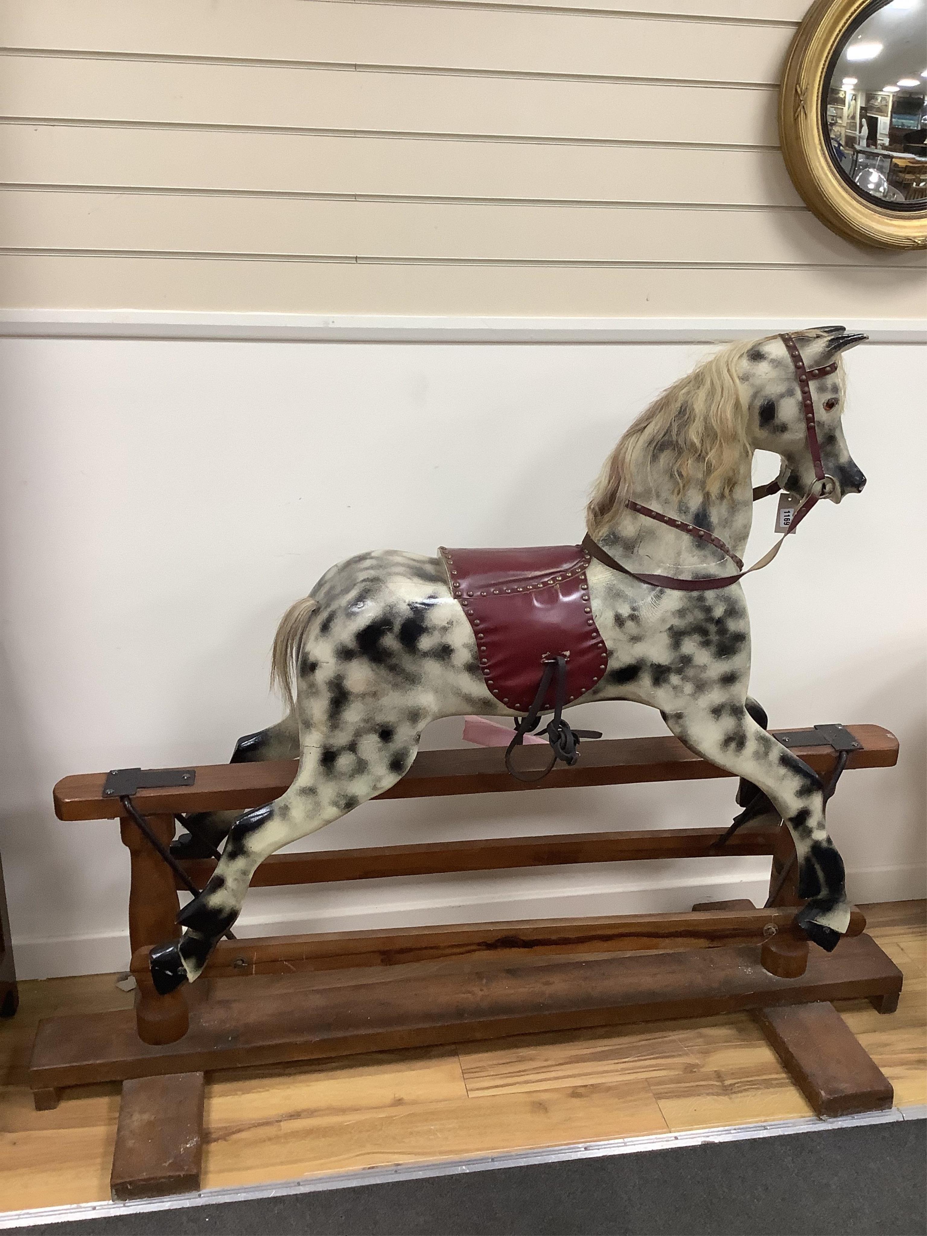 A large mid 20th century dapple grey rocking horse, on pine safety frame, length 168cm, height 135cm. Condition - fair